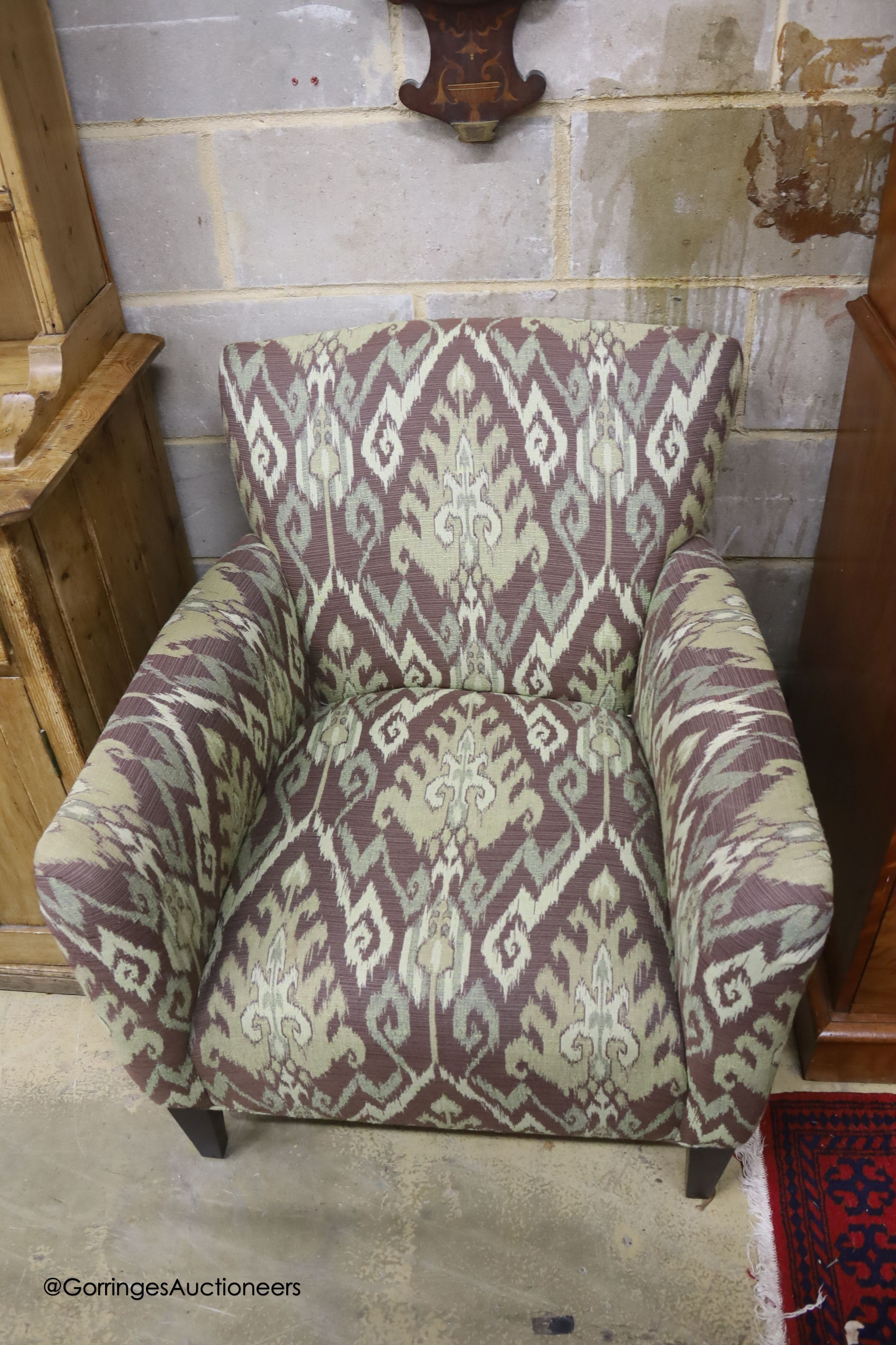 A Kelim upholstered armchair and matching footstool
